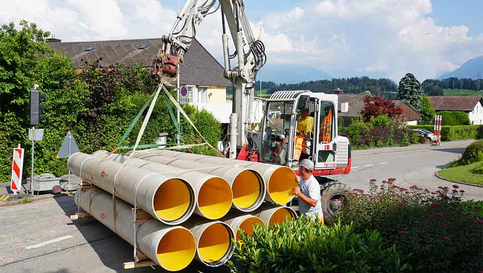 Flowtite Orange pipes on forklift for stream culvert project in Eschenbach, Switzerland